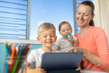 Mother schooling her child at home. Children education, and parenting concept. 