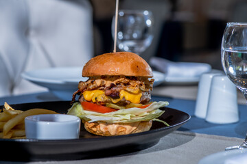 delicious big juicy hamburger on the table in the restaurant