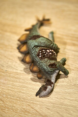 A vertical shot of the Collecta brand dead Stegosaurus with wounds dinosaur figurine. © Mirco Vacca/Wirestock
