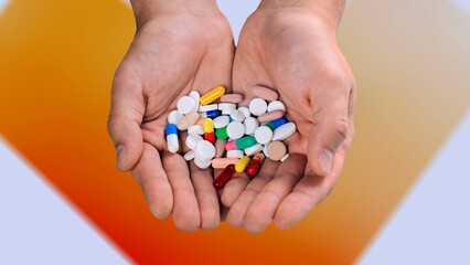 Doctor's hand holding a set of medical pill