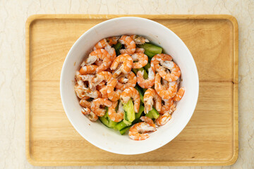 salad made of fresh shrimps and cucumber in a bowl
