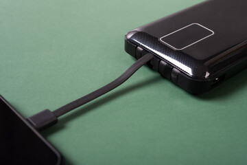 portable power bank charging a smart phone