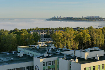 Fototapeta premium Fog over the city in the morning. Autumn morning fog.
