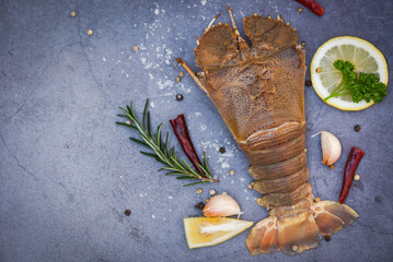 Raw flathead lobster shrimps with herbs and spices, fresh slipper lobster flathead for cooking on...
