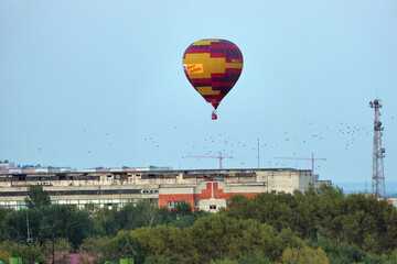 Fototapeta na wymiar Nizhny Novgorod, Russia, 08.19.2021A colored balloon in the sky over the city. Close-up, isolated.