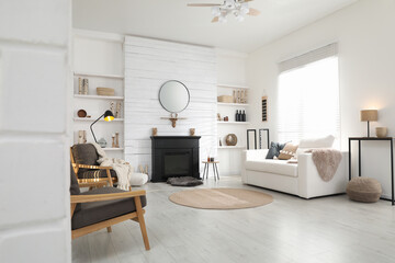 Cozy living room interior with comfortable furniture and modern electric fireplace