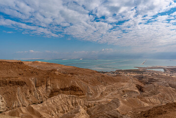 View of the desert mountains and the Dead Sea from an official viewpoint above the Dead Sea in Israel.
