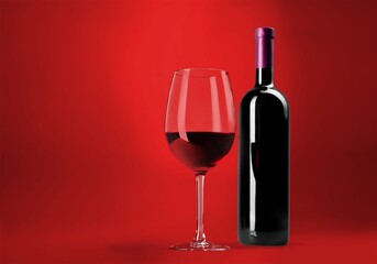 Red wine glass over colored background on the desk