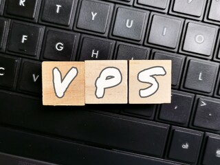 Wooden cubes with alphabets VPS on keyboard buttons.