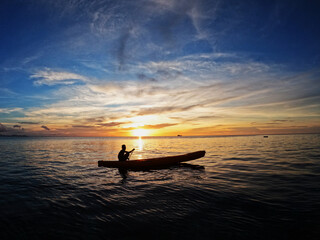 Naklejka na ściany i meble Silhouette of young men on Kayak