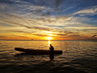 Naklejka na ściany i meble Silhouette of young men on Kayak