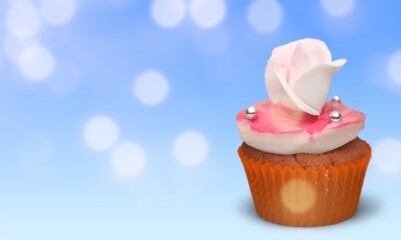 Chocolate cupcake decorated with icing and sprinkles