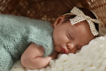 Adorable newborn baby sleeping on soft plaid, closeup