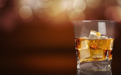Glasses of alcohol stand on desk of cognac in wine cellar illuminated by soft light