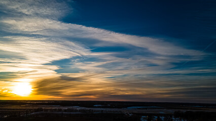 Vibrant beautiful winter sunset with angelic clouds