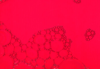 Beautiful soap bubbles on a red color background