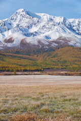Altai lake Dzhangyskol on mountain plateau Eshtykel. Grass is covered by hoarfrost. Altai, Siberia, Russia