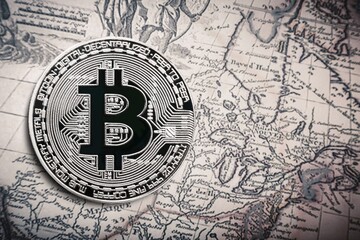 bitcoin legalization metal bitcoin crypto currency coins on a map of the world.