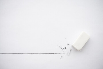 Flat lay of white eraser delete black line pencil on white paper background copy space. Repair,...