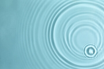 Closeup view of water with circles on turquoise background