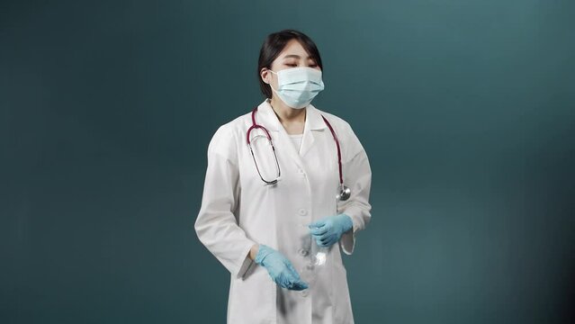 A tired upset woman in a medical uniform is putting a special equipment off and rubbing her forehead