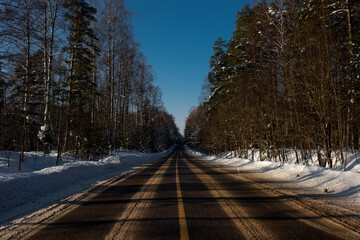 Highway road in winter forest