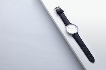 Men's watch with leather strap and white dial, isolated on a white background