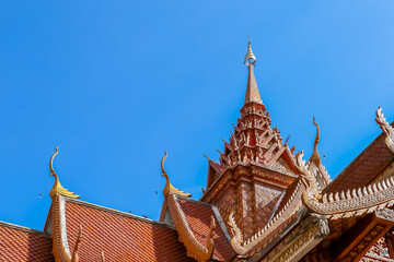 Fototapeta premium Thai style roof of Buddhist temple with blue sky.