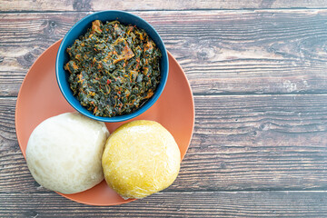 Garri and Pounded Yam served with Efo Riro Vegetable Soup