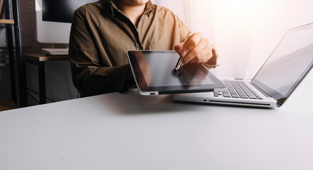 Close up of two asian colleagues working together, have a discussion and using laptop computer at office with financial document on desk
