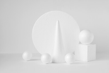 White geometric podiums for product demonstrations. Three-dimensional balls, circle, cone, square...
