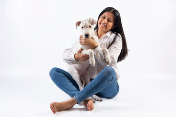 Obraz na płótnie Canvas Young lady with affectionate white dogo Argentino dog on white background