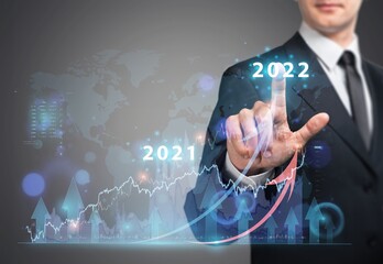Businessman or trader showing glowing virtual technical investment graph chart for analysis stock market