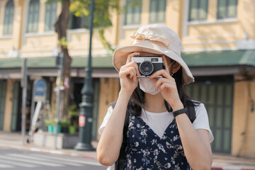 Traveler, travel asian young woman or girl use camera take photo, old town street, city tourism on happy sunny day. Backpacker tourist, holiday trip, summer or vacation, hobby concept.