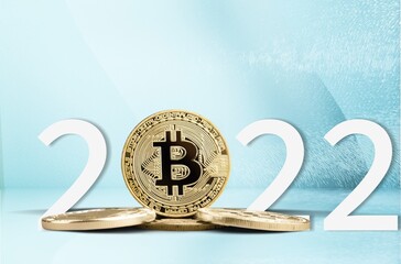 Bitcoin 2022 price prediction concept. Btc coin standing next to year numbers on background.