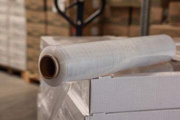 Roll of stretch wrap on box in warehouse