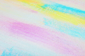 Strokes of different pastel acrylic paints on white canvas, closeup