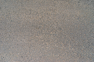Smooth concrete real road with cracks and clutch track. Great for travel and urban purposes. Rough road texture background. Rough cracked asphalt, small gravel road