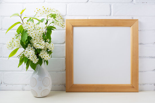  Square wooden picture frame mockup with bird cherry bouquet