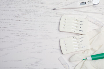 Disposable express hepatitis test kit on white wooden table, flat lay. Space for text