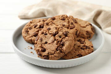 Delicious chocolate chip cookies on white wooden table, closeup