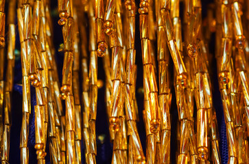 Texture of golden bugles and glass stones. Selective focus.