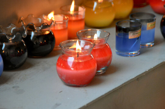 Close-up Cozy Red Burning Candle In All Clear Glass Jar.