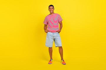 Fototapeta na wymiar Full length photo of guy put hands pockets demonstrate trend summer cool look isolated over shine yellow color background
