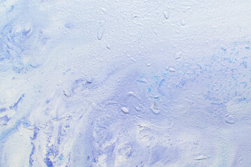 abstract creative background: oil paint frozen in a container after dilution, light color toning, short focus.