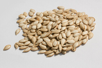 Heap of pumpkin seeds isolated on white background