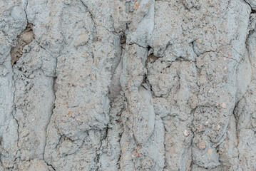 Cracked concrete wall gray cement surface background.cracked grey stone wall in winter.close-up.