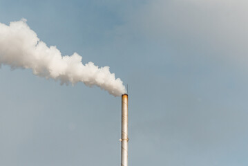 Pipe and smoke.Polluting air with white smoke from industrial chimney outdoors. CO2 emissions.Copy space.