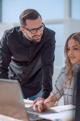Fototapeta premium business colleagues using a laptop to work with documents