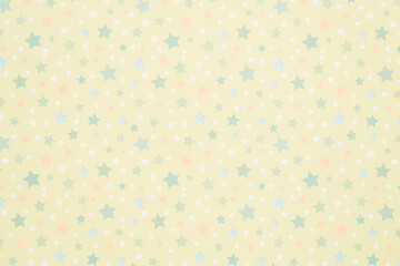 Star-shaped patterns of various colors against a yellow background.